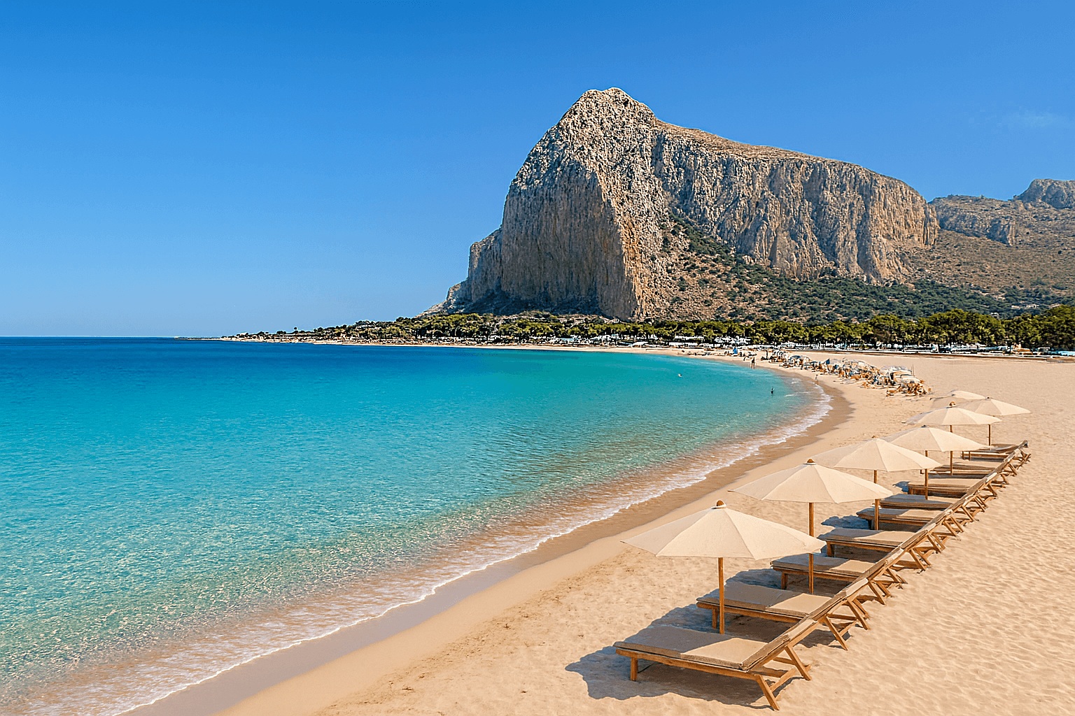 San Vito Lo Capo luxury beach with Monte Monaco, Sicily Luxury sunbeds on San Vito Lo Capo beach in Sicily with turquoise sea and Monte Monaco in the background